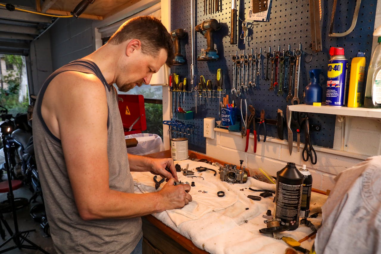 A mechanic working on engine parts in a well-organized garage in Orlando, Florida.